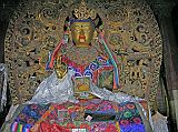 Tibet 06 06 Gyantse Pelkor Chode Another Maitreya Further on in the Pelkor Ch�de there was another statue of Maitreya, the future Buddha. This one is a little bit different in that he is sitting cross-legged. You can see one of his symbols on the right, what looks like a teapot.